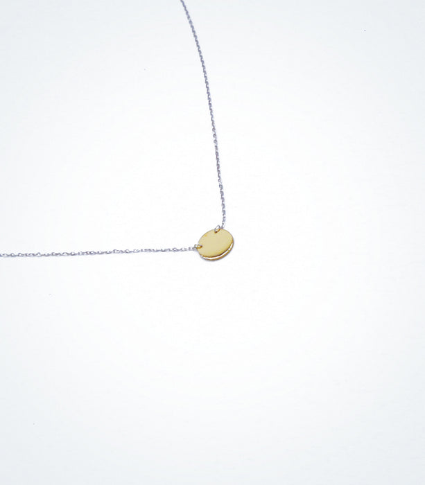 Yellow gold Solid Circle motif with a white gold chain necklace