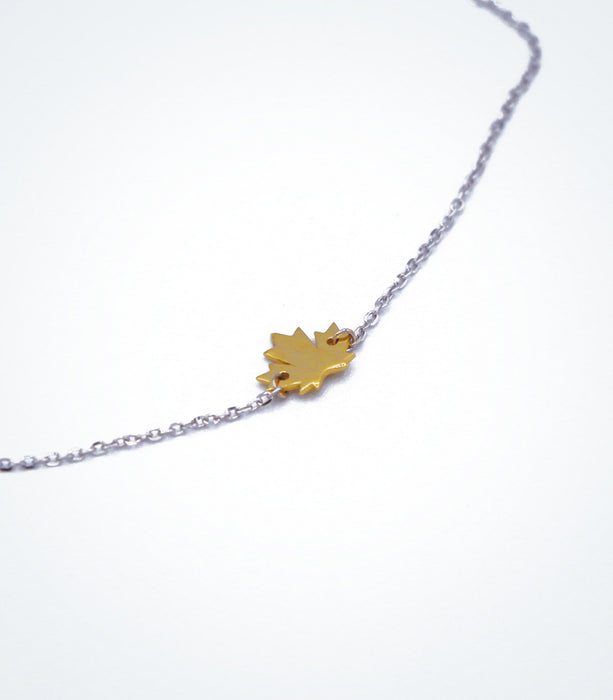 Yellow gold Maple Leaf motif with a white gold chain necklace