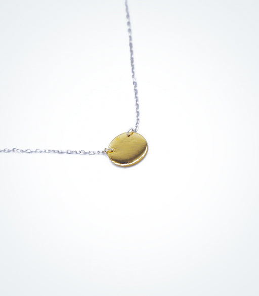 Yellow gold Solid Circle motif with a white gold chain necklace